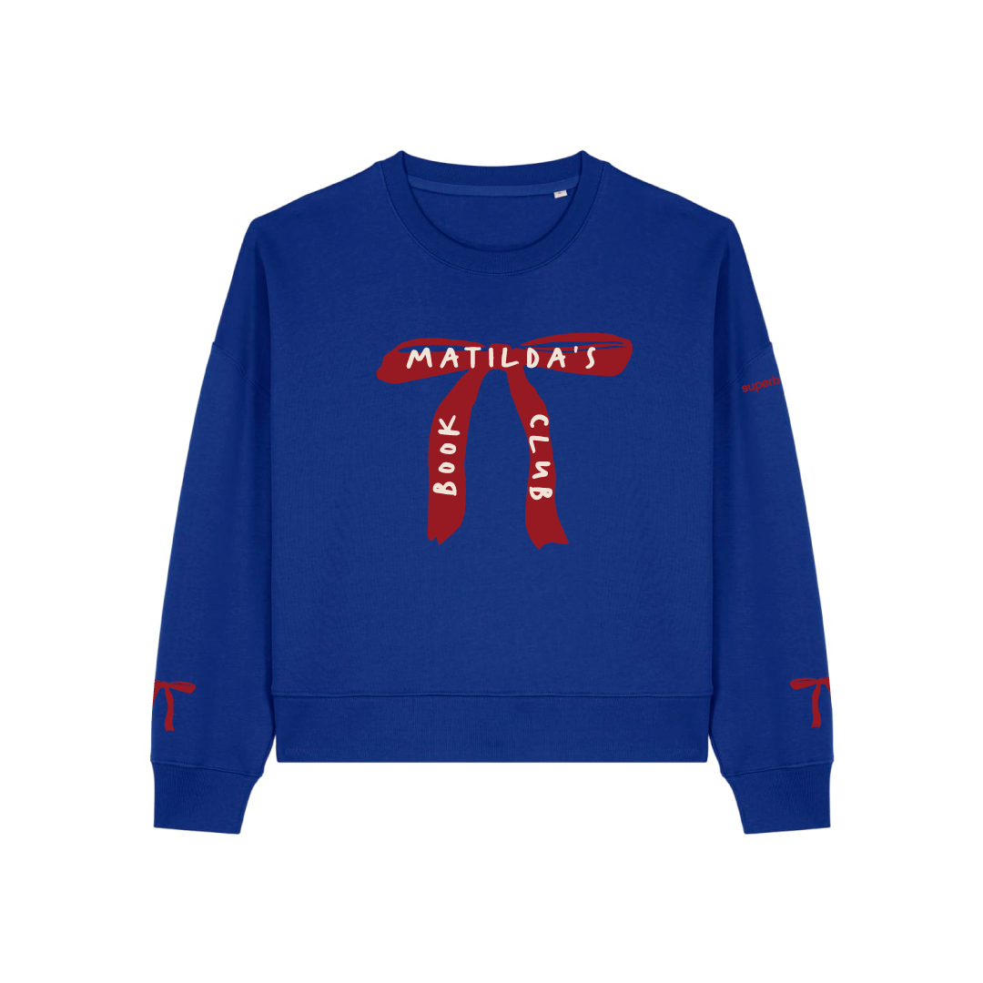 Sudadera con bordado inspirado en Matilda, película de 1996 basada en la novela homónima del escritor británico Roald Dahl. Es de color azul con un gran lazo rojo en el pecho donde se lee Matilda's Book Club. Tiene dos lazos rojos bordados en las mangas.