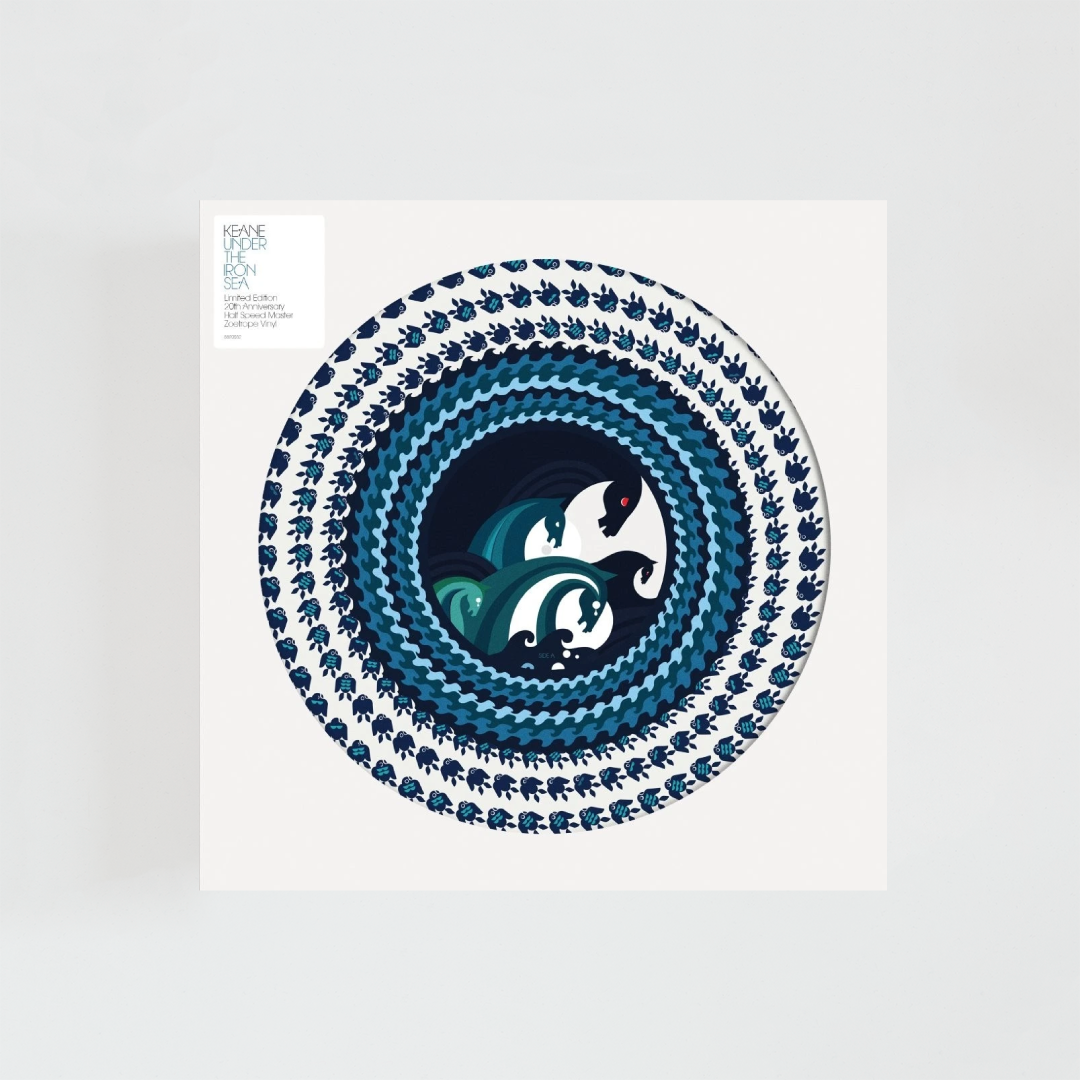 Edición 20.º aniversario de Under the Iron Sea de Keane en formato Picture Disc de 180 gramos, con funda blanca de apertura circular que deja ver el diseño ilustrado del vinilo y una etiqueta con la información de la edición especial.
