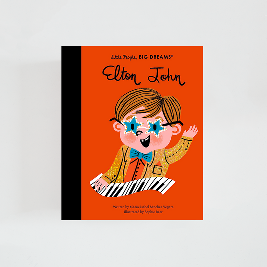 Portada del libro Elton John de la colección Little People, BIG DREAMS. Ilustración de Elton John con gafas llamativas y vestuario colorido. Fondo naranja y título destacado en la parte superior.