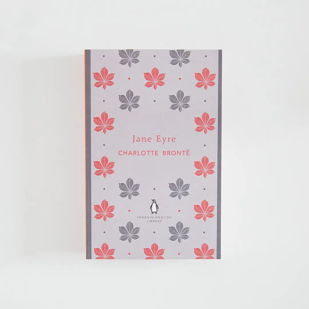 Portada gris y roja del libro en inglés Jane Eyre de Charlotte Brontë de la colección Penguin English Library sobre fondo blanco.
